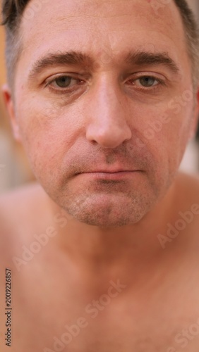 Fotografi Vertical photo Gentle postshaving skincare observational scene, Serene man inspe