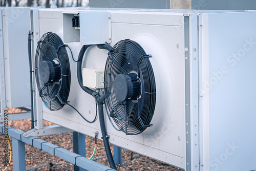 Rooftop HVAC unit with multiple fans and condensers delivering efficient cooling and ventilation for commercial building systems