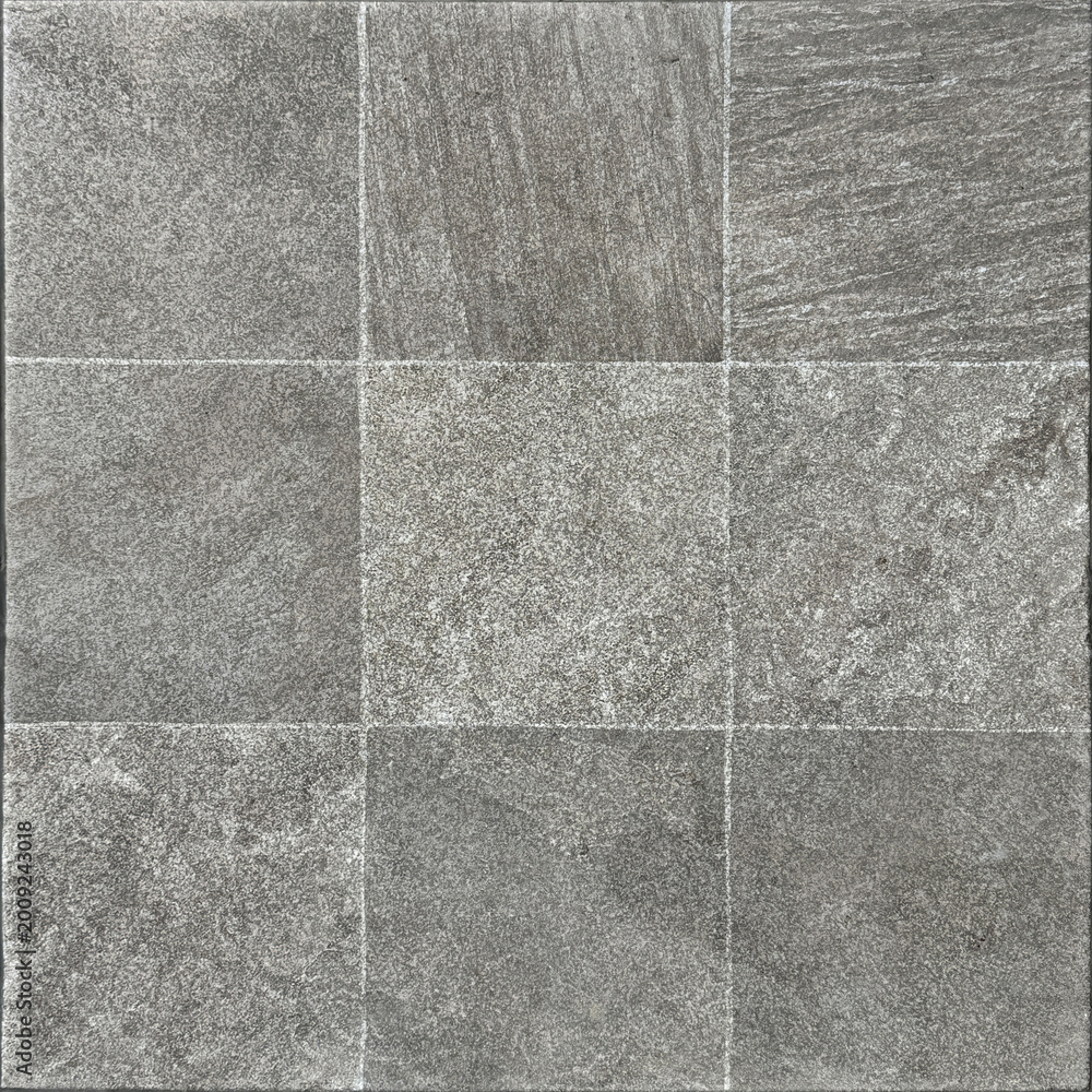 Fototapeta premium Close up of natural rough grey slate stone tiles with dark abstract veins. Honed and rough outdoor stone cladding tiles wall. Seamless background texture.