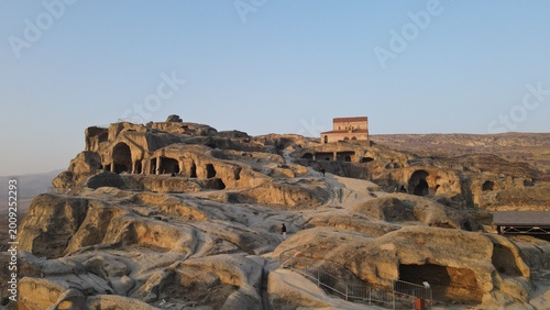 Photos Ancient cave city Uplistsikhe with stone chambers and church at sunset in Georgi