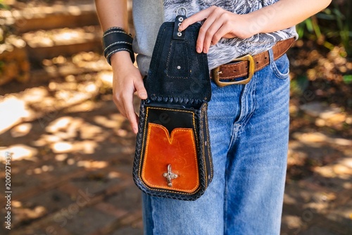Fotografie Open leather waist bag worn with denim outfit