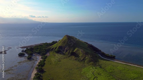 Pulau kenawa island hiking hill with clear ocean. Unique aerial view drone