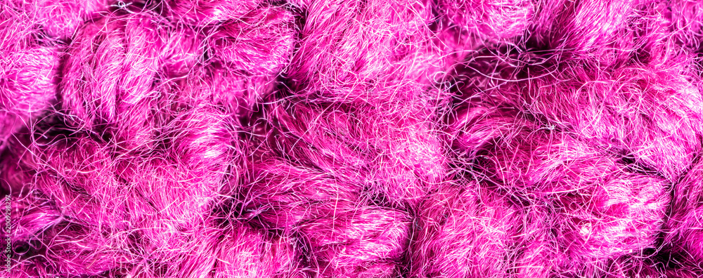 Obraz premium Knitted woolen fabric pattern in rich magenta