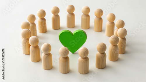 Wooden figures forming a circle around a bright green heart on a white background, community support, team unity, environmental care concept.