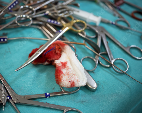 Surgical instruments blood stained gauze operating room. Professional medical tools stainless steel equipment arranged for spine surgery procedure clinical neurosurgery orthopedic treatment healthcare