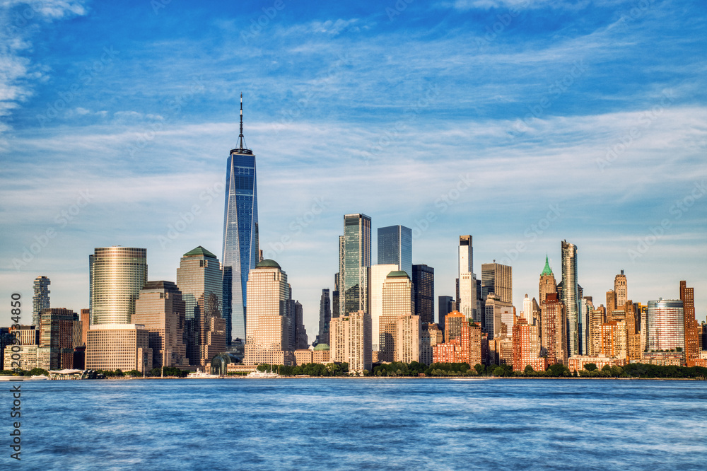 Fototapeta premium Illuminated New York City Skyline View at Sunset, New York