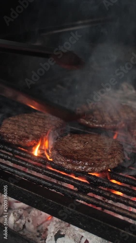 Summer barbecue grill out cook flips flame grilled burger and hot dog sausages