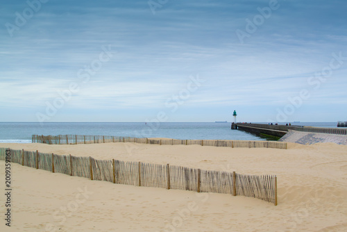 Calais beach in northern France, promenade near the sea, coastline, sand, dunes, France, La Manche, people walking far away, a large beach