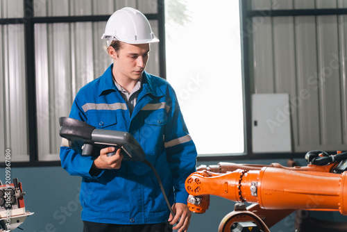 Foto Robot operator control panel auto production factory worker safety helmet engine