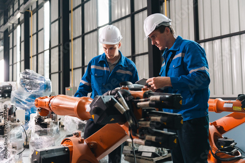 Fotografie Robot arm worker engineer auto manufacturing factory teamwork inspection industr