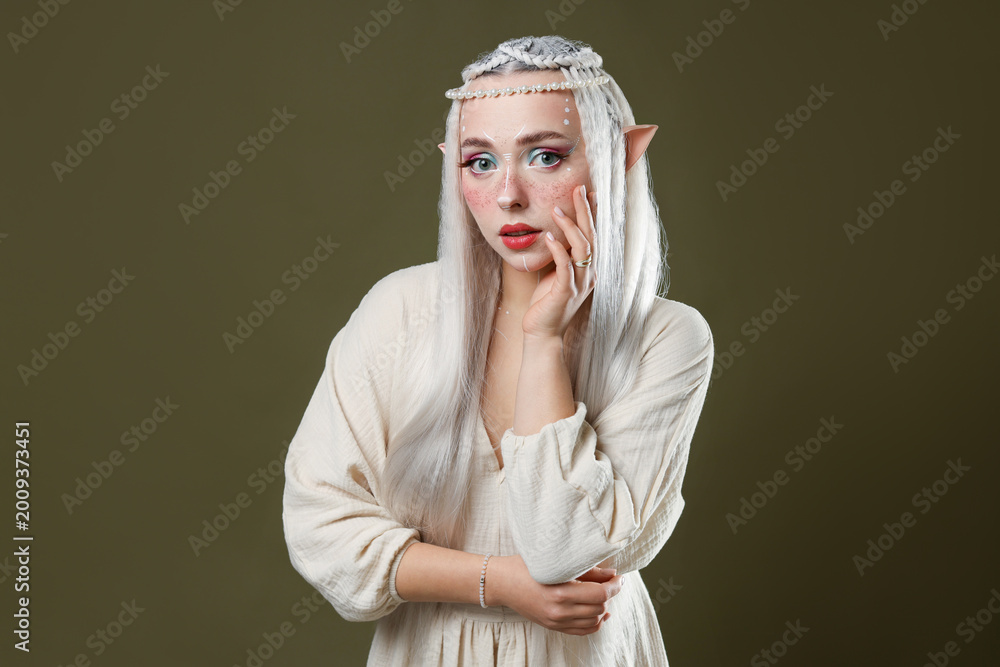 Fototapeta premium Beautiful elf girl on dark olive background