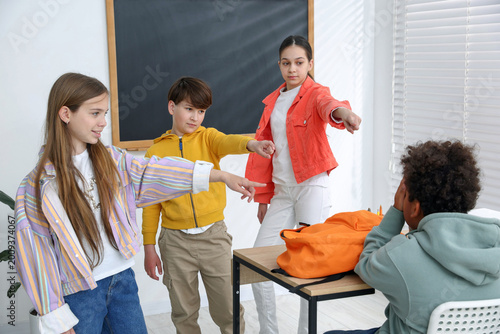 Cuadro en lienzo African American boy getting bullied by his classmates in classroom