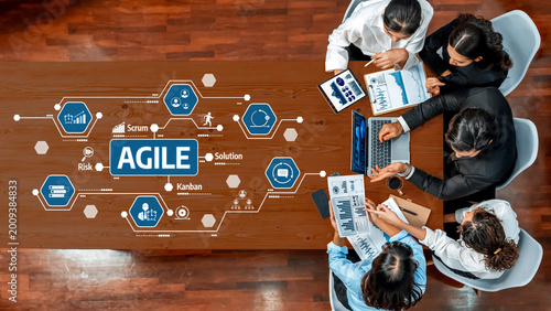 Tableau sur toile A diverse team engages in a collaborative meeting, analyzing agile methodology concepts using data charts and technology tools on a modern conference table
