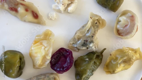 Assorted handmade dumplings on white plate close up