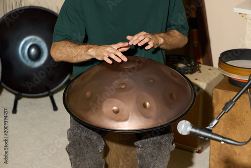 Slika na platnu Intimate scene of hands producing soothing melodies in home studio