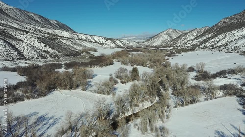 Aerial view of Grass Valley and Hogback Ridge in Garfield County, Colorado after heavy snowfall on cold clear February morning 4K.