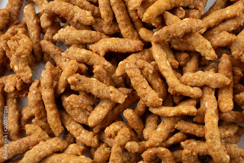 A top down view of a pile of sesame sticks snack, as a background.