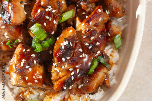 A top down view of a teriyaki chicken rice bowl.