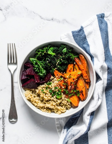 Colorful buddha bowl with quinoa, sweet potatoes, beets, and greens