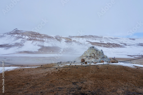 Photos Geothermal Fumarole and Steam Vent in Snowy Volcanic Landscape With Visitors in