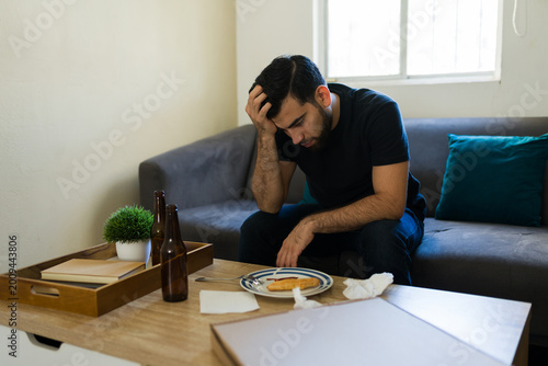 Fotografie Depressed man experiencing sadness and despair, struggling with mental health is