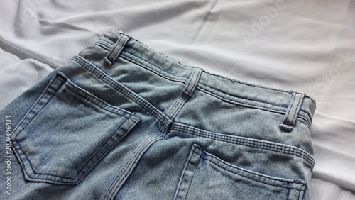 Bilde på lerret Close-up detail of the back of light blue denim jeans, showcasing classic pocket