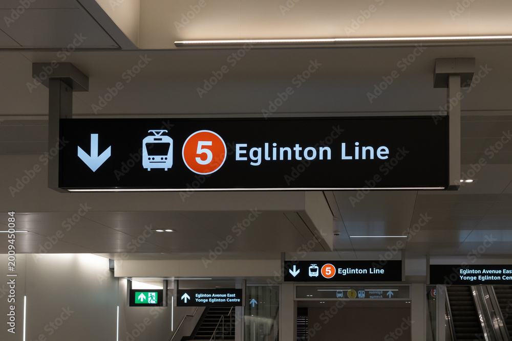 Fototapeta premium Toronto, ON, Canada - May 4, 2026: A sign hanging from the ceiling at a station on Eglinton Crosstown LRT (Line 5) in Toronto, ON, Canada. The Eglinton Crosstown LRT is a new rapid transit line in Tor