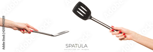 Female hand hold spatula. Isolated on a white background 