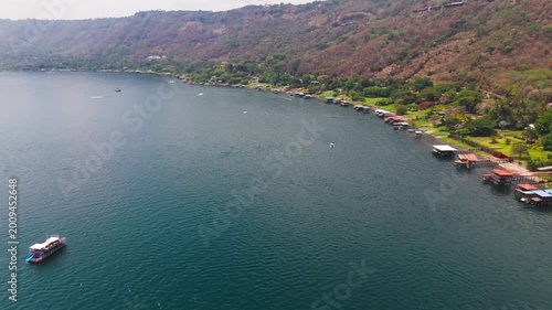 Aerial view of Lago de Coatepeque in El Salvador. Cinematic footage captures a wide shot of the lake