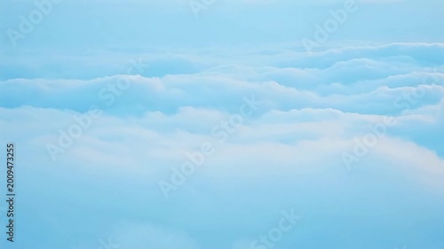 Beautiful tranquil landscape above the clouds, showcasing a horizon of light blue and white formations extending infinitely