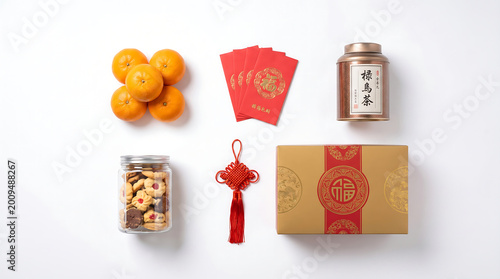 Chinese New Year Gift Set Flat Lay with Mandarins Red Envelopes Tea and Cookies on White Background. Traditional Lunar New Year Concept for Festive Marketing and Celebration Advertising.