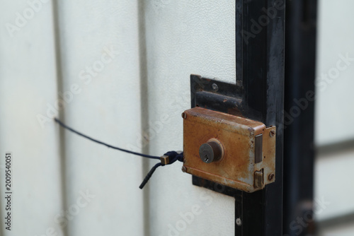 Tableau sur toile Close-Up of a Rusty Vintage Rim Lock Secured with a Makeshift String Tie