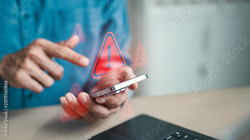 Bild auf Leinwand User holding smartphone with red warning alert icons, representing cyber threat detection, mobile security risks, privacy breaches and digital protection against online attacks