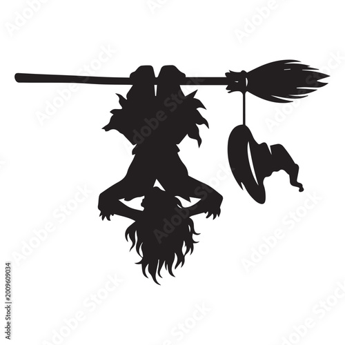 Foto Playful witch silhouette hanging upside down from a broomstick