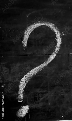 Conceptual background of a hand-drawn question mark on a vintage chalkboard.