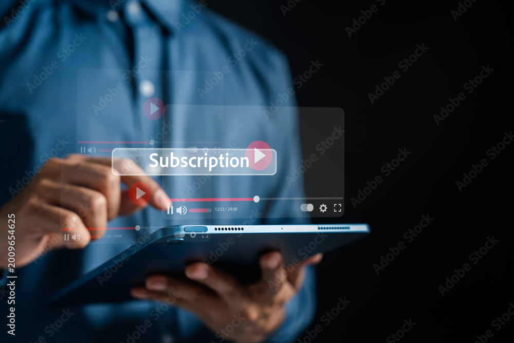 Naklejka premium Video streaming subscription and premium media entertainment solution. Man using tablet to play movie and access online content.