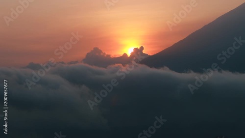 Sunset above the clouds with Mount Agung silhouette in Bali