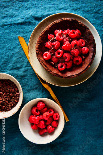 Chocolate Basque Cheesecake with Raspberries and Chocolate on Blue Linen Tablecloth