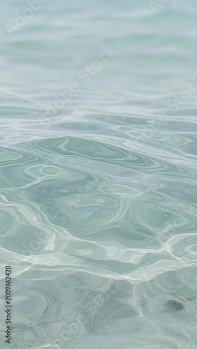 Calm Clear Turquoise Water Surface Rippling With Sunlight Reflections and Tiny Bubbles