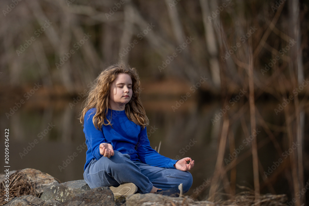 Naklejka premium Child in a daydream. Carefree childhood in nature. Dreamy kid. Thoughtful child. Little child dreamer. Young mind full of imagination. Blonde child thinking. Kids freedom. Calm and peaceful childhood.