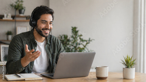 Happy man video call using laptop