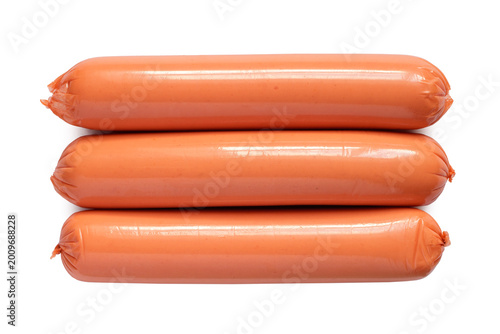 Three sausages on a white background. Thin long sausages close-up.