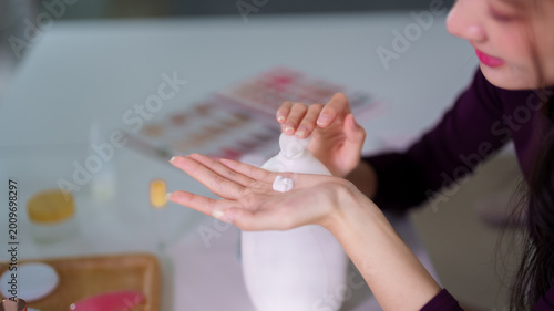 Quadro su tela Caucasian women applying moisturizer hand cream lotion skincare beauty routine w