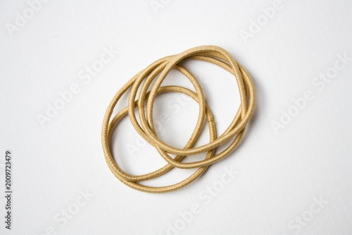 Heap of cream hair ties on white background