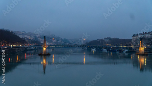 Passerelle du Collège Bridge at Dusk over Saône River in Lyon, France with Reflections and City Lights