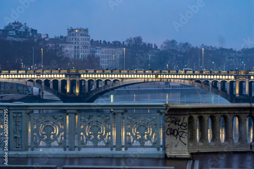 Passerelle du Collège Bridge at Dusk over Saône River in Lyon, France with Reflections and City Lights