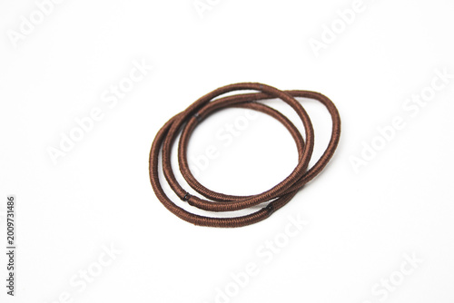 Heap of brown hair ties on white background