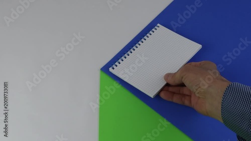 A spiral notebook on a tabletop with a colored surface, creating a sense of copy space and chroma key