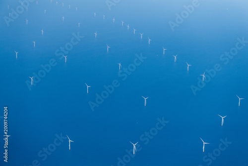 Aerial shot of a modern wind turbine park in the North sea, off the coast of the Netherlands.