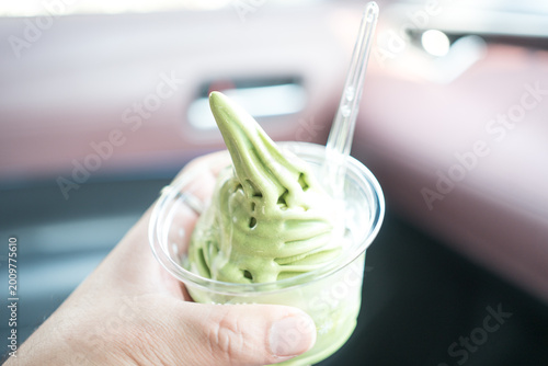 A delicious green matcha soft serve ice cream on hand